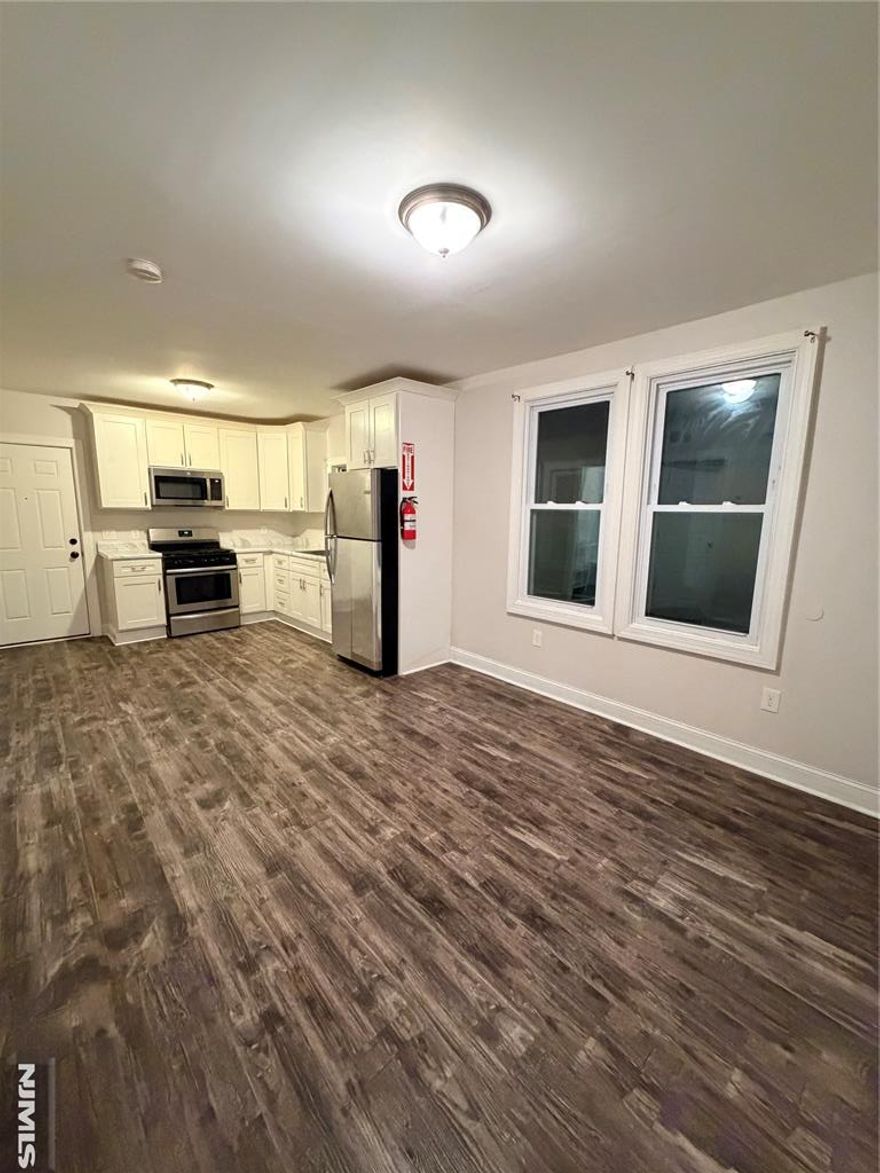 Welcome to 469 Alden Street, Orange. This first floor apartment was recently renovated and retouched, just awaiting its next residents. It is comprised of three bedrooms, one bathroom and an open kitchen and living room area. The kitchen has stainless steel appliances and ample cabinet space. The apartment features laminate wood floors, central air conditioner, forced air heating and plentiful closet space. The apartment also includes exclusive use to one of two car garages, providing valuable storage space. Conveniently located near shopping, dining, parks, schools, and houses of worship, this apartment offers easy access to everyday necessities and community amenities. Residents will appreciate being just blocks from bus stops, minutes from major highways, and only 0.9 miles from the Orange Train Station, offering direct access to New Jersey and beyond. This apartment offers the perfect combination of space, location, and modern updatesâ€”making it an ideal place to call home. Donâ€™t miss this opportunity!