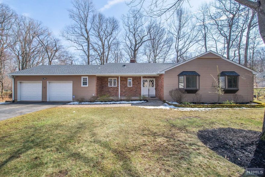 Beautiful, Sprawling, Ranch! Fabulous Floor Plan. The amount of flexible living space is impressive. Bright & Sunny. TONS of entertaining space. Formal LR & DR w/brick faced WB fireplace that carries through to the wall in the eat-in kitchen with gas cooking! Convenient powder room & pantry/laundry. Gorgeous HW flooring & large windows! Double sliders to partially covered back deck. 3 generous sized bdrms equipped w/lots of closet space & each with their own bay window. The Master showcases a built-in desk, 3 roomy closets & full bath w/stall shower. 2nd full bath- all handicap modified. Downstairs, huge, flexible unfinished space! Tons of storage or potential to finish. High ceilings & walkout, already insulated just waiting to be sheetrocked. Double garage & long driveway sits proudly at the end of a quiet Cul-de-sac. Gorgeous property situated in this lovely section of Morris Plains. Just a short walk to NYC Mid-Town Direct Train & Downtown Morris Plains.