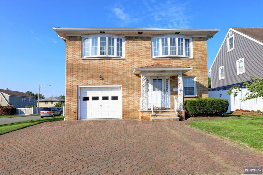 Absolutely gorgeous custom built all brick raised ranch with full finished basement in top Wallington location!! First floor consists of a large entry foyer with double coat closets, Huge open living room with natural gas fire place, dining area, full kitchen, large bedroom, large laundry room and full bath. Sliding glass doors lead to a beautiful covered backyard patio. Second floor includes a large family room, formal dining room, eat in kitchen, full bath, 3 spacious bedrooms and master bedroom with half bath. Full finished basement with 3 rooms, wet bar and full bath. Hardwood floors throughout! Multi Zone Hot water baseboard heat and central air conditioning. Steps away from NYC transportation. Close to shopping, parks and schools!!