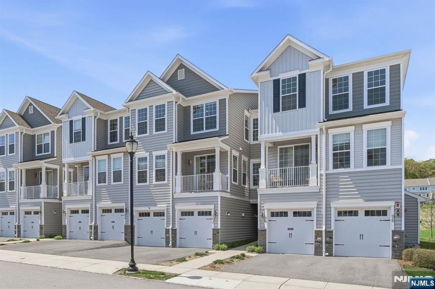 Welcome to the highly coveted Yale model in the breathtaking Hilltop at Cedar Grove! Built five years ago, this immaculate townhome offers the perfect blend of style and sophistication. The gourmet kitchen features stainless steel appliances, granite countertops, and an open-concept layout that flows seamlessly into the bright living and dining areas with soaring ceilings. The main level showcases luxurious vinyl plank flooring, a large pantry/storage closet, powder room, and a private balcony ideal for morning coffee or evening sunsets. Upstairs, discover three spacious bedrooms, including a serene primary suite with a spa-like bath and expansive walk-in closet. The second and third bedrooms are generous in size, complemented by a bright loft area, full bath, laundry room, and oversized storage closet. Finished with custom lighting, detailed woodwork, and ready for you to just move right in. Enjoy a one-car garage, driveway parking, and resort-style amenities including the clubhouse, infinity-edge pool, fitness center, BBQ area, and shuttle to Upper Montclair Train Station. Adjacent to Cedar Grove Park and Hilltop Reserve, with close proximity to dining, shopping, and major highways, this home offers the best of suburban luxury with urban convenience. Experience resort-style living at its finest.