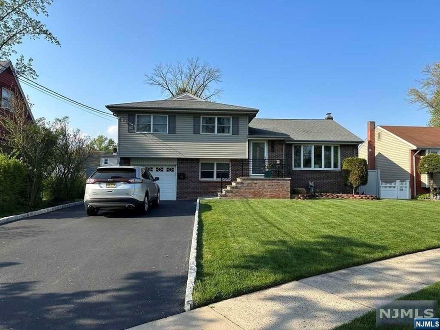 Discover this beautiful split-level home in Bergenfield, NJ, ready for immediate occupancy and meticulously cared for. The main level features a spacious living room, a formal dining room with deck access, and a modern kitchen with a breakfast bar. Upstairs, you'll find a primary bedroom suite, two additional bedrooms, and a full bathroom. The ground level boasts a versatile rec room, an extra bedroom, another full bathroom, and access to the back patio. The basement offers a recreational room, utility area, and laundry room. With the convenience of an attached garage, this home seamlessly blends modern living with timeless charm. To set a private showing, please contact Eileen directly @ 201.220.0579. Listed by CENTURY 21 Concept 100 201.385.7100