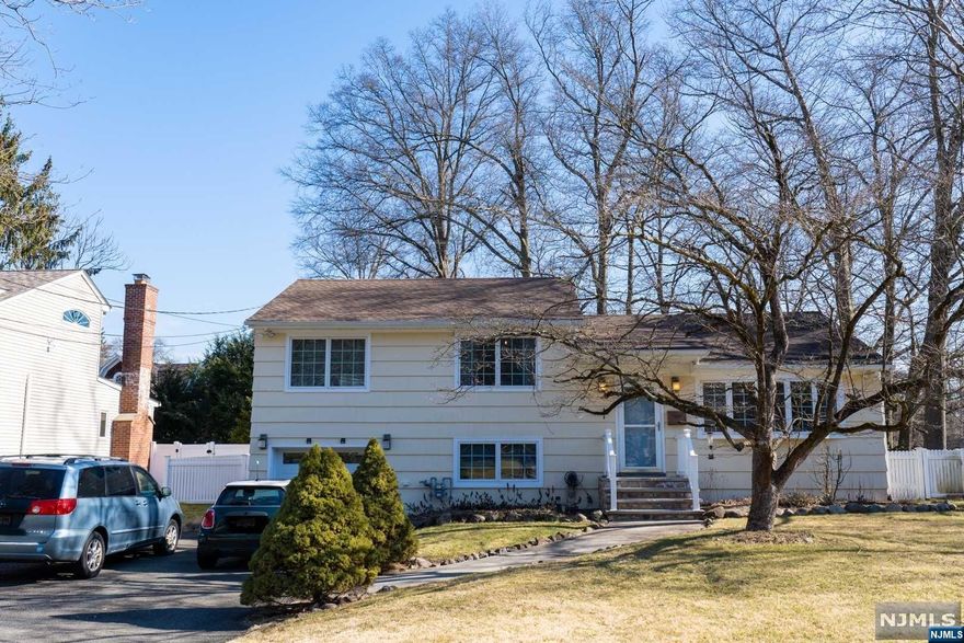 Fantastic opportunity in the highly desirable town of Glen Rock! A wonderful Split Level Home on a nice level property in a tree lined quiet residential street. Beautifully updated inside and out, this 3 bedroom, 2 full bath home with hardwood floors throughout the house. Appealing open floor plan with living room, updated gourmet kitchen and dining room with exit to a patio and fully fenced backyard. Master Bedroom with a beautiful renovated bathroom and 2 additional bedrooms with full bath. On the ground level - family room / office and access to the garage and laundry. Lots of updates - a newer roof, kitchen, hot water on demand system, electric, front stairs, backyard patio and so much more. One car attached garage + 6 parking spaces. Top rated schools, wonderful town pool, charming downtown shopping and dining, easy commute to NYC.