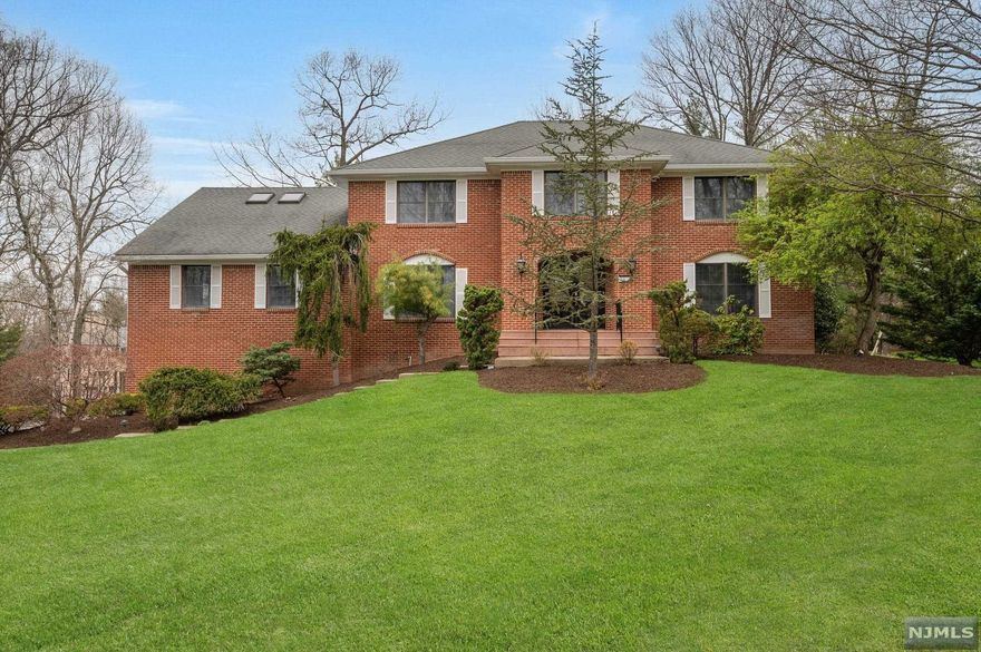 Very spacious Colonial set in beautiful Mansions of Montville. Double door entry welcomes you into an open, light filled foyer. Freshly painted throughout in neutral palette, hardwood floors, crown and custom molding. Large eat in kitchen with center island and walk-in pantry will streamline meal prep. Double sliding doors from kitchen and family room allow access to large deck overlooking private back yard. 2 bedrooms and a full bath on first floor perfect for in-law suite. Master bedroom with ensuite including spa bath, skylights, dressing/office area and walk-in closet. 3 additional bedrooms and full bath on second floor. Full basement with access to 3 car garage, rec room, playroom, exercise/office and storage. New 7 zone high energy efficient gas heating, 2 new AC units, new hot water heater, new water softener, new gutters. Convenient location nearby Towaco Village and NYC transportation. Award winning school system. 29 mi to NYC!