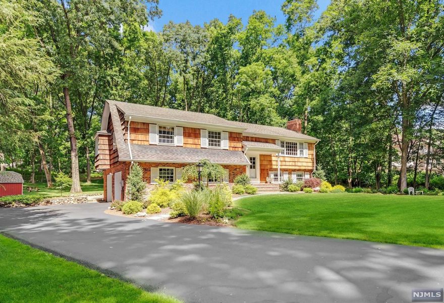 Beautifully remodeled bi-level nestled on an acre of lush grounds at the end of a quiet cul-de-sac. Enjoy private relaxation and entertaining with friends and family on the private deck in the scenic, completely private backyard. Enter into an interior with modern upgrades throughout, and living spaces illuminated by natural light. Bright chef's kitchen features stunning Calacatta Gold marble countertops and stainless steel appliances. Large living room and chic formal dining room, both with hardwood floors, trendy light fixtures. Spacious primary suite with a newer primary bath & access to the large deck and three additional bedrooms that share a full hallway bath complete the main level. On the ground level, you will find a spacious family room with fireplace, office/additional bedroom, half bath, laundry, and backyard & garage entry. Two-car garage & plenty of driveway parking space. Outstanding location just a short distance from quaint downtown Ho-Ho-Kus and train.