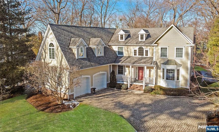 Nestled on 0.5 acres at the end of a highly private cul-de-sac, this elegant 1994 custom-colonial exudes timeless sophistication. A grand foyer draws you into a voluminous interior with hardwood floors, high ceilings & detailed millwork throughout. Spacious living room & formal dining room seamlessly flow into an expansive window-lined open layout consisting of a beautifully appointed 2-story great room with fireplace & a gourmet eat-in kitchen. A private library with exquisite woodwork, powder room, mudroom & 2 car garage complete the 1st level. Fabulous vaulted ceiling primary suite with a skylight-lit full bath. Plus, 3 bedrooms- 2 sharing an ensuite, a hall bath, laundry & a large potential 5th bedroom/family room easily accessible by 2nd staircase on upper level. Basement rec room offers a rock wall and temperature-controlled wine room. Entertain on the oversized patio with a built-in grill overlooking a completely flat backyard. Acclaimed Willard E.S. just a block away!