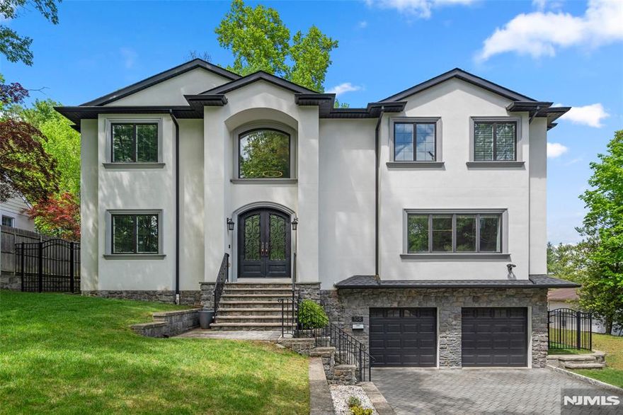 Welcome to this stunning 5-bedroom, 4.5-bath Colonial-style home offering over 5,000 square feet of luxurious living space. A grand two-story foyer greets you upon entry, leading to elegant formal living and dining rooms complete with a convenient butlerâ€™s pantry. The spacious two-story great room features a cozy fireplace and seamlessly opens to a gourmet eat-in kitchen, boasting custom cabinetry, marble countertops, a large center island, and top-of-the-line appliances. Upstairs, the open hallway overlooks both the foyer and great room, enhancing the home's airy feel. The primary en-suite includes a generous walk-in closet and spa-inspired bath. A junior en-suite, two additional bedrooms, and a full bath complete the second floor. The fully finished basement offers exceptional additional living space, including a cherry wood wet bar, recreation area, a guest bedroom and full bath, a dedicated gym/storage room, and access to the attached 2-car garage equipped with an EV charger. Enjoy outdoor living year-round in the completely fenced backyard, featuring a patio with a hot tub and mounted heatersâ€”ideal for entertaining. Additional highlights include a state-of-the-art backup generator and a spacious 6-car driveway. Ideally located within walking distance to top-rated Blue Ribbon schools, parks, library, shopping, and an NYC express bus stop.express bus stop. It's must see! Seller is the Listing agent.