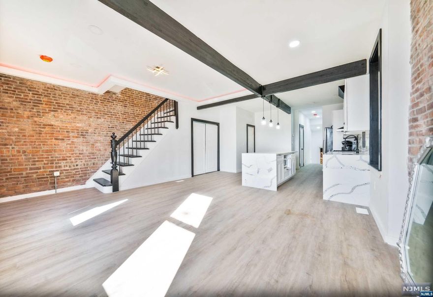 Completely Gut Renovated Large Colonial. Beautiful quartz kitchen tops, everything new. Open floor concept. 3 floors of living space with approximate 2550 sq feet. 5 bedrooms, 4 full baths. Full finished basement with wet bar, large backyard and so much more. 10 minutes to Lincoln Tunnel, 5 minutes to NJ Turnpike and all major highways. 3 blocks from light rail. Close to schools, parks, house of worship, restaurants, public transportation at corner. House is located in an opportunity zone with some tax benefits.