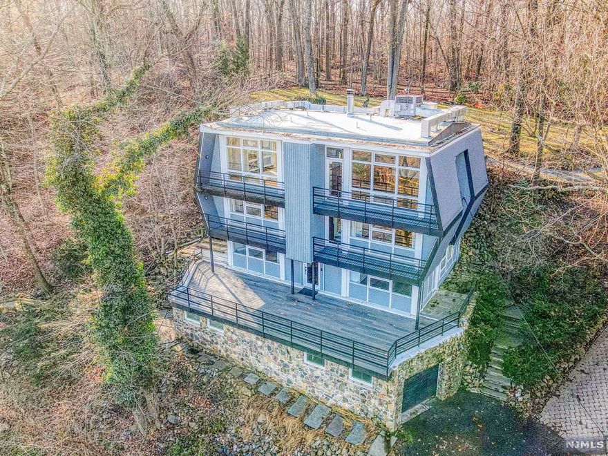 HOUSE OF THE SKY - Upper Montclair, you found it once, but this time it's yours.. An Exemplary example of Mid Century Modern Technique and Philosophy allowing Nature's Inspiration to sunbathe daily with Sunrise over the NYC Skyline and Sunset over Mills Reservation. The needs of the entire family are met with 3 Story Living Spaces, separate bathrooms and work areas. An Open Layout supports the Best of Both Worlds: a Family room entered from Glass Doors off a Grand Deck (where Stargazing is the new past time) to the Top Floor where Entertaining is effortless, wood in the Fireplace crackling among the oohs and ahhs of the View from floor to ceiling windows. Magnetized and pampered by the Luxurious Master Suite, complete with Spa Bathroom, Den/Office and Private Balcony. Your Lifestyle is complete with Outdoor Living perfectly intermingled with Convenience to NYC and the Superb Local Treats of Montclair. All the work has been done, now come and enjoy Life.