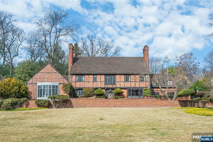 Magnificent architectural gem picturesquely situated on 1.71 acres of well maintained, exquisitely cultivated grounds with seasonal views of Manhattan. This custom built majestic English Manor home in the Mountain District of Montclair, was designed by the noted NYC architects Harvey Stevenson and Eastman Studds and completed in 1933. Lovingly constructed with artisan detailing the manor is replete with stunning period details imported from England in 1929 including lavish wood paneling, leaded windows, Grand stairway imported from England with hand carved newel post, intricately carved fireplace overmantel, enriched plaster ceilings with tracery, hardwood flooring and custom solid wood doors throughout. The Great Room is a wonderful example of Montclairâ€™s finest high-style architecture with a soaring vaulted ceiling, hand hewn beams, large spectacular fireplace with intricately carved overmantel and leaded oriel windows that overlook NYC skyline in front and French doors in back opening to a private landscaped sanctuary. Historical decorative elements and iconography adorn the exterior and interior of this elegant home with four fireplaces, five bedrooms, 5.1 bathrooms, oversized updated kitchen with breakfast room opening to a patio, den/library with fireplace, 1st floor office, formal dining room, expansive Great Room, and spacious primary ensuite bedroom with fireplace. This property boasts a swimming pool/hot tub, badminton/croquet court and 3 car heated garage. The gr