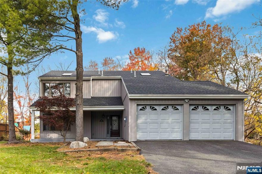 Are you looking for a 4 bedroom colonial close to the center of town in Westwood? This custom-built home offers privacy and approx. 2200 sq ft of living space with hardwood floors throughout, a primary suite with skylights, wood-burning fireplace, and a 2 car garage. The front porch leads to the main entry with a new door, tiled EH, large front-to-back living and dining room, a family room with raised hearth stone-faced fireplace, large backyard, and SGD to wraparound deck. The 2nd floor features a primary bedroom with vaulted ceilings, a walk-in closet, and a full bath. There are also 3 large bedrooms with a full bath. Other amenities include parquet hardwood flooring, a 2 car garage, refrigerator, washer/dryer, central air conditioning, & 3 zone gas baseboard heat. Updates include siding, roofing, gutters, and central AC. This home is just a few blocks away from the highly desired downtown Westwood shopping & train station. Schedule your private showing before it's too late!