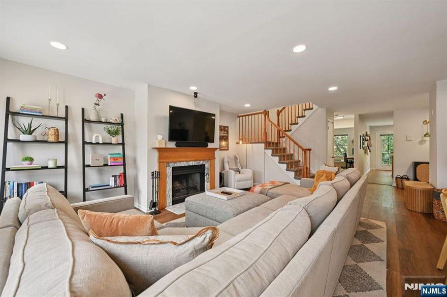 Experience the rare privacy of a dual-level layout at Montclair Mews with a highly coveted garage. This isn't just a 2-bedroom residence; it's a thoughtfully designed townhouse-style retreat that prioritizes light, volume, and vertical separation. This home opens into a grand, sun-soaked Great Room. Anchored by a classic fireplace and fresh flooring, you will love hosting meals with so much space for everyone to relax comfortably. The kitchen has updated SS appliances and beautiful counters but you'll love having a private balcony, perfect for your breakfast or morning espresso. This level also features a spacious secondary bedroom and full bathroom, offering ideal separation for guests, a gym, or a den. Retreat upstairs to a floor dedicated entirely to your rest. The primary suite is a true "penthouse" sanctuary, featuring ceilings with skylights that flood the bedroom and en-suite bath with natural light. With three closets and a versatile bonus alcove, perfect for a high-end home office, this level offers a quiet "away zone" from the main living area. Enjoy second-floor laundry, garage parking, and manicured grounds with a charming gazebo. Located directly across from the Bay Street train station and minutes from the Walnut Street Farmers Market and the Wellmont Theater, this is Montclair living at its most convenient. Bike storage has also been secured for the avid biker as a bonus.