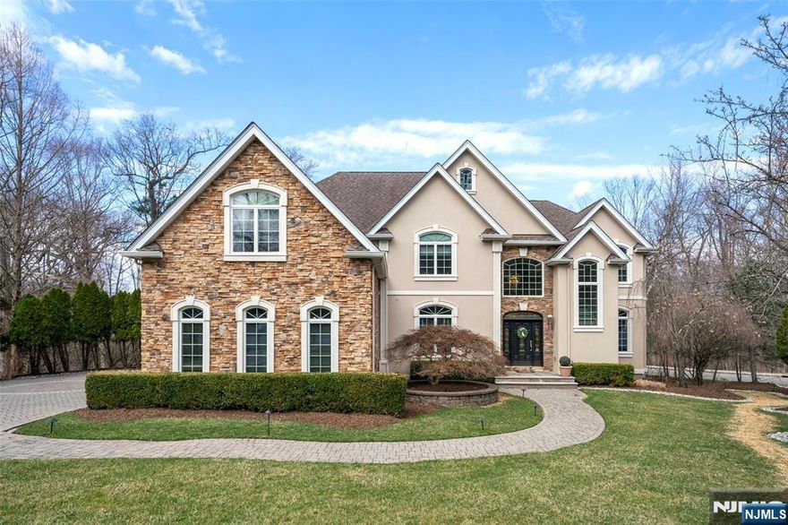 Luxury Living in a Private Cul-de-Sac! Stunning modern colonial set on an expansive 40,900 SF lot, offering approximately 6,000 SF of elegant living space. This 6-bedroom, 4.5-bath home features a sun-filled open floor plan, beautifully landscaped grounds, three single-car garages, and updated HVACs. The first floor offers a dramatic two-story foyer and floor-to-ceiling windows. Enjoy a breathtaking two-story great room with a fireplace, a bedroom, an office, a powder room, a formal dining room, a full-size deck, a balcony, a mudroom, and a gourmet kitchen with a commercial-grade vent system. Upstairs, the expansive primary suite offers a fireplace, private balcony, walk-in closets, and bathroom. The second floor is complete with a junior suite, two additional bedrooms, a full bathroom, and a laundry room. The fully finished walk-out basement opens to the backyard and features an entertainment room, a movie screen with sound system, a gym, an additional bedroom, and a full bathroom.