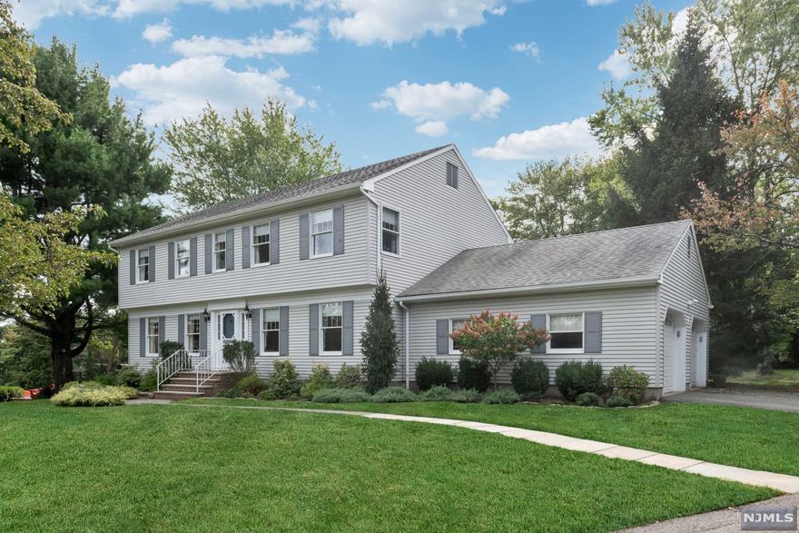 Tucked on a quiet cul de sac in the sought-after Sicomac area, this charming center hall colonial awaits your personal touches. Whether you take advantage of the existing floor plan or expand on this private half acre lot, you will be surrounded by mature trees and luxury properties. Characterized by gleaming wood floors and oversize windows, the main level offers a stunning front to back living room with stone-front fireplace; a formal dining room; a freshly remodeled kitchen with quartz countertops, seated center island, and direct access to the roomy 2-car garage; and a comfortable adjacent family room. The second floor includes 4 bedrooms, including a primary suite with dedicated bath. A spacious lower level with tall ceilings is the perfect place for additional recreation space. For outdoor options, enjoy the oversize deck with pergola that overlooks the rolling lawn. Highly rated schools and municipal water/sewer are some of the perks - a rare find, packed with potential!