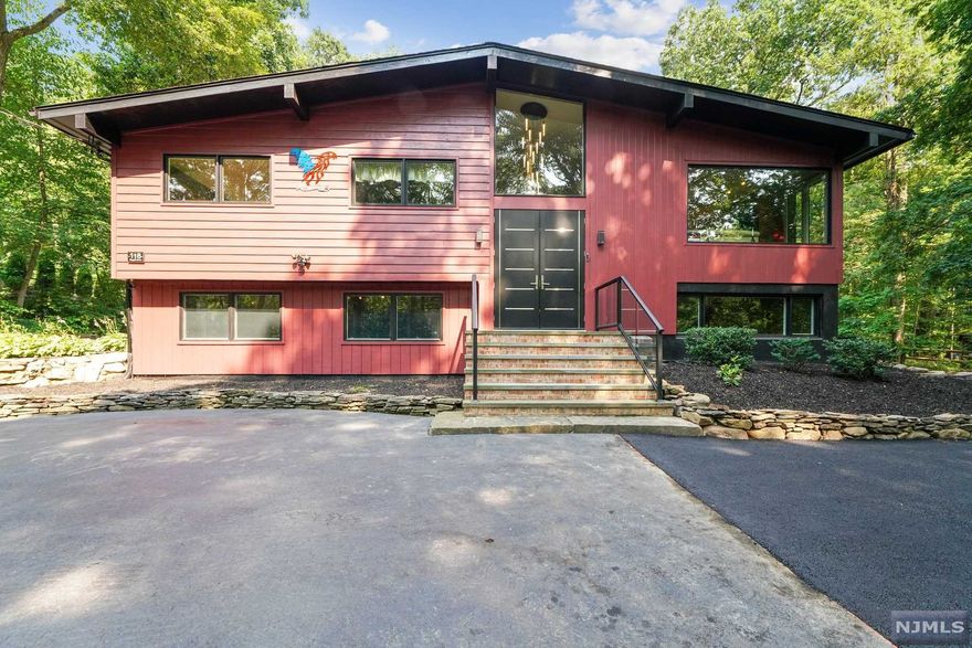 If you love nature and poolside living, this is your dream home. A secluded retreat surrounded by beautiful mature trees backing up to acres of undeveloped, mountainside land yet convenient to Rt 287. This contemporary bilevel boasts large windows overlooking your own nature preserve. LR with fireplace. Formal DR with sliders. 2 bedrooms up with primary ensuite bathroom & tons of closet space. Ground-level offers a bedroom and 1/2 bath (could be full bath), family room with fireplace. Separate garage has electric car charger. The large entertainment-size deck surrounds an above-ground heated 24x12 rectangular pool which has a UV-coated plexiglass sliding enclosure for additional enjoyment. Built-in house generator with wired manual transfer. Pool 2014; roof 2016; windows 2017, Priority road snow removal.