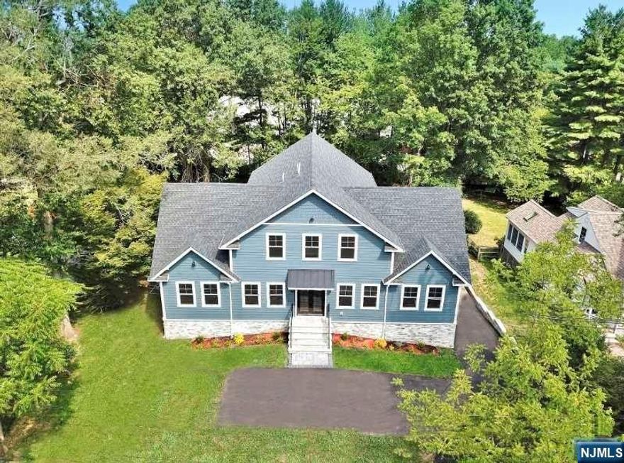 Experience unparalleled luxury in this stunning new construction custom-built 7 bedroom, 5 1/2 bathroom residence, offering nearly 5,500 square feet of sun-drenched living space on a deep and expansive property in the prestigious Chatham Twp. Designed with an open-concept floor plan and great room that includes bedrooms on all three floors, this home boasts gleaming Santos Mahogany oak hardwood flooring and is ideal for elegant and modern living. The gourmet kitchen is a chef's dream ensuring a top-tier culinary experience equipped with top-of-the-line Signature SS appliances, custom cabinetry, quartz countertops, and a waterfall edge center island that seats six. The master suite is a luxurious haven, featuring a roomy walk-in closet and a spa-like bathroom. The West Wing of the home has a bedroom suite and two generously sized bedrooms with a main bath. On the second level, this large family room space provides a perfect retreat for both entertainment and relaxation.