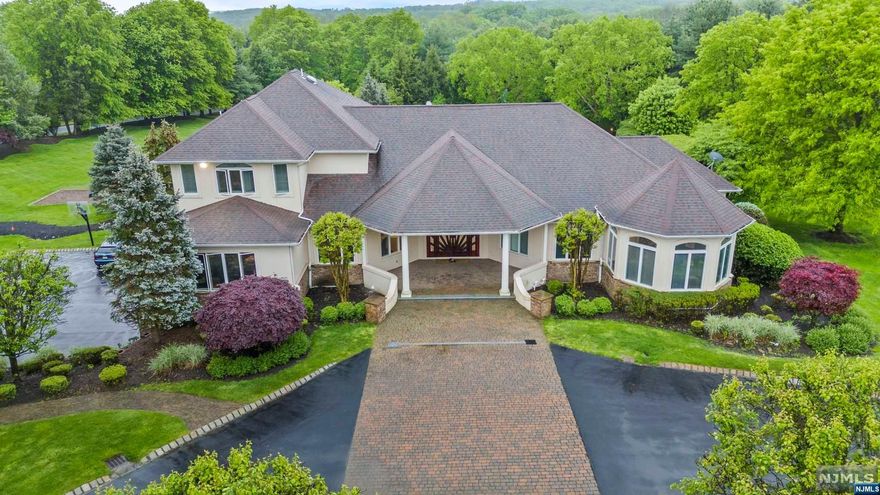 Welcome to your dream home nestled within the prestigious enclave of Fawn Valley Hills. Situated on an expansive 5.15-acre estate, this property epitomizes luxury living at its finest. Spanning across 6 bedrooms and 7 1/2 bathrooms, this home offers unparalleled space and comfort for you and your loved ones. A grand 4-car garage provides ample parking and storage, while the full finished walkout basement, featuring 2 bedrooms and 2 full bathrooms, offers versatility and convenience. The heart of the home lies within the gourmet kitchen, adorned with sleek black leather granite countertops and equipped with top-of-the-line stainless steel Jenn Air appliances, including the impressive Jenn Air Rise gas range with 6 burners. Whether you're hosting intimate gatherings or grand celebrations, this kitchen is sure to impress even the most discerning chef. Step outside into your own private oasis, where a breathtaking 75-foot wide Gunite saltwater heated pool awaits.