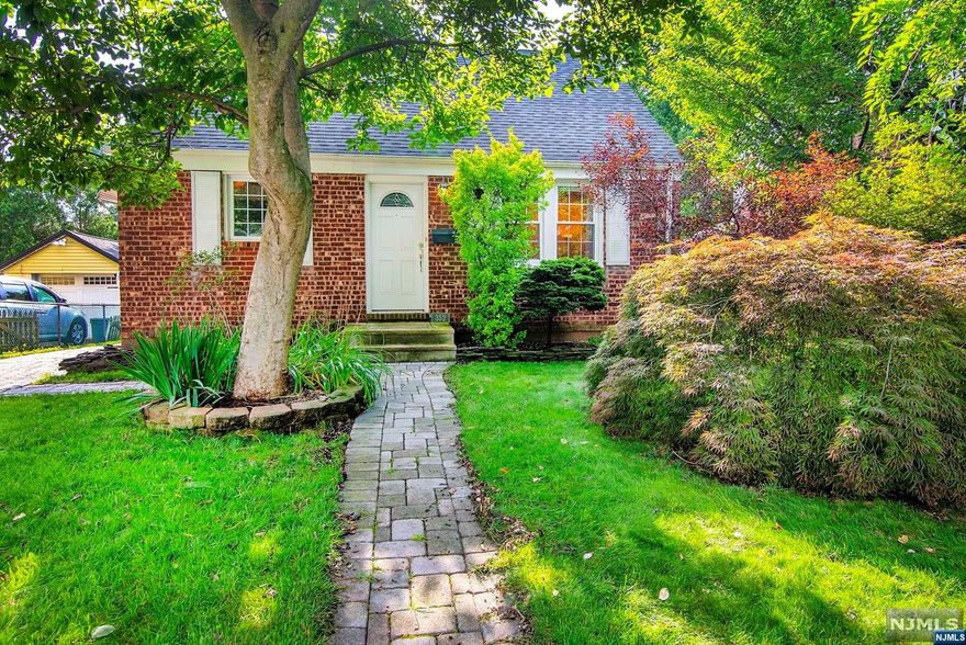 Welcome to this move in ready brick cape cod style home. This home offers restored natural wood trim, hardwood floors, three bedrooms, a new boiler, a finished basement level with a new full bath, laundry room, and outside entrance. The private, level back yard has an oversized detached garage with plenty of room for storage and a paver driveway. Walking distance to schools, parks and NYC transportation. A solidly built brick home with many important updates and desirable old-world details.