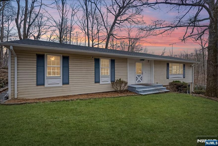 A peaceful backyard retreat, and natural stream adds to the charm of this beautifully updated 3-bedroom, 2-bath home. Inside, you'll find new luxury vinyl flooring in the foyer, living room, and bedrooms, plus a freshly painted interior. The standout kitchen features granite countertops, stainless steel appliances, and a brand-new slider leading to the new deck perfect for enjoying the stream and seasonal lake views. Both bathrooms are tastefully updated, with ceiling fans throughout the main level. Enjoy the partially fenced yard, full-house alarm system, and peace of mind with a new roof, gutters, gutter guards, and chimney flue. Unlike many homes in Hopatcong, this one is on public sewer. Just around the corner from Crescent Cove Beach Club and close to marinas, parks, and restaurants. Move-in ready schedule your showing today!