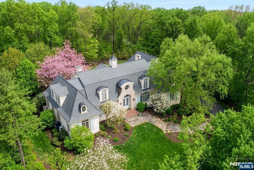 Tucked away at the end of a private cul-de-sac in one of Franklin Lakesâ€™ most prestigious enclaves, this custom-built estate exudes timeless elegance and the inviting warmth of the European countryside. Crafted by a renowned local builder, the home is a masterclass in quality construction and thoughtful design- featuring intricate millwork, solid wood doors, 10-foot ceilings, and floor-to-ceiling windows that flood the interiors with natural light. Set on a beautifully landscaped acre, the property offers complete privacy and a serene backdrop for everyday living. The exterior spaces are as impressive as the interior, highlighted by a gunite pool, stone terraces, and lush gardens. Inside, approx. 7,000 sf showcase exceptional craftsmanship and architectural detail. The newly designed Ulrich kitchen serves as the heart of the home, complemented by a stunning breakfast room with walls of glass overlooking the private backyard oasis. The flowing layout includes both grand entertaining spaces and intimate gathering rooms, along with a desirable 1st fl guest suite. Upstairs, 4 additional bedrooms and 3 luxurious baths provide comfort and privacy, while the finished lower level expands the living space for recreation or fitness and connects to a 4 car attached garage. A rare blend of old-world sophistication and modern luxury, this extraordinary residence is ideally located near top-rated schools, shopping, and everyday conveniences-delivering the ultimate Franklin Lakes lifestyl