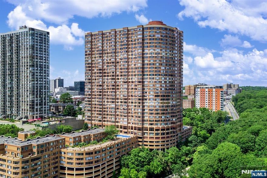 Experience luxurious living in this beautifully updated condo just 20 minutes from NYC. This home features brand-new stainless steel appliances, recessed lighting, elegant wood floors, and fresh paint throughout. Residents enjoy world-class amenities, including 24-hour doorman and concierge service, state-of-the-art fitness center, visitor valet parking, outdoor pool with BBQ area, childrenâ€™s playroom, dog park, and on-site management. Relax in the landscaped courtyard and deck with tables and seating, all while taking in breathtaking NYC skyline views. This residence also comes with two deeded parking spots, offering both convenience and comfort in a prime location.