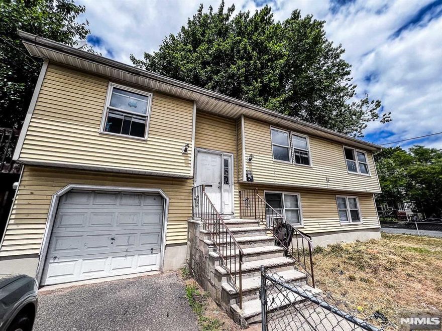 This versatile two-family home on a prime corner lot offers flexible living options with ample parking for up to four cars. Unit 1 features an open-concept layout with a spacious living area, three bedrooms, two baths, new floors, a renovated kitchen, a huge deck, and convenient garage access. Unit 2 includes two bedrooms and a full bath, perfect for rental income or to live. Modern updates and a convenient location make this an ideal choice for homeowners and investors alike don't miss out!