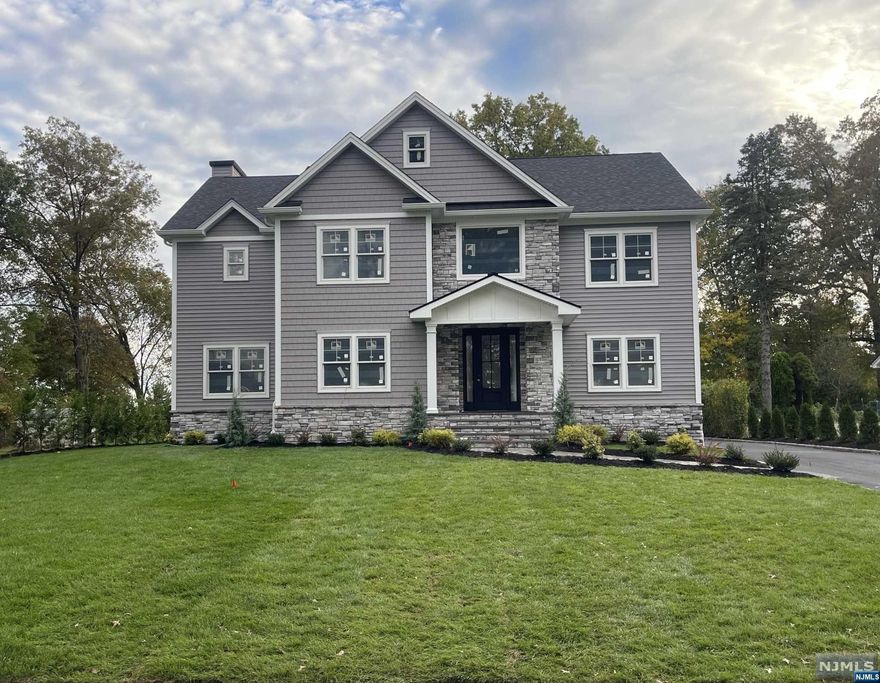 Stunning new construction home by Gjoni Construction LLC located on a dead end street and backing into the golf course. Open layout of approx. 4,800 SQFT of living space including a full finished basement with an office, full finished bathroom, bar and plenty of storage. Modern colonial design with 5 bedrooms including one on the first floor and 5.5 bathrooms. Beautiful hardwood flooring throughout the entire house, 9" foot ceilings throughout, custom trim and molding, and a spectacular kitchen with high-end appliances. The kitchen features include; a center island with quartz counter top and custom cabinetry with plenty of storage. The primary bedroom includes gorgeous vaulted ceilings, a walk-in closet, en-suite full bath with a large shower, free-standing tub, and custom tile throughout. Located in a wonderful area of Livingston within walking distance to bus stops, amazing restaurants and shops!