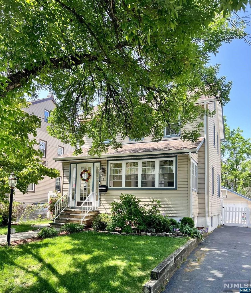 Beautifully renovated side hall colonial with nothing to do but unpack. Enter into the enclosed, front porch to be enjoyed year round. Then into the main living space with open concept throughout. Generously sized living room opens into the kitchen/dining room that is beautifully updated with quartz countertops and SS appliances. Back door in kitchen leads to deck and huge patio for unlimited enjoyment in the fenced backyard. Upstairs you'll find a tastefully renovated bathroom and 3 bedrooms. Walk up attic providing tons of storage space and potential for expansion. The full finished basement offers plenty of room for a home office and playroom. Equipped with a full bath and separate laundry space. A huge 2 car garage as an added bonus in the backyard provides everything you could want. Come fall in love with this beautifully landscaped move-in ready gem.