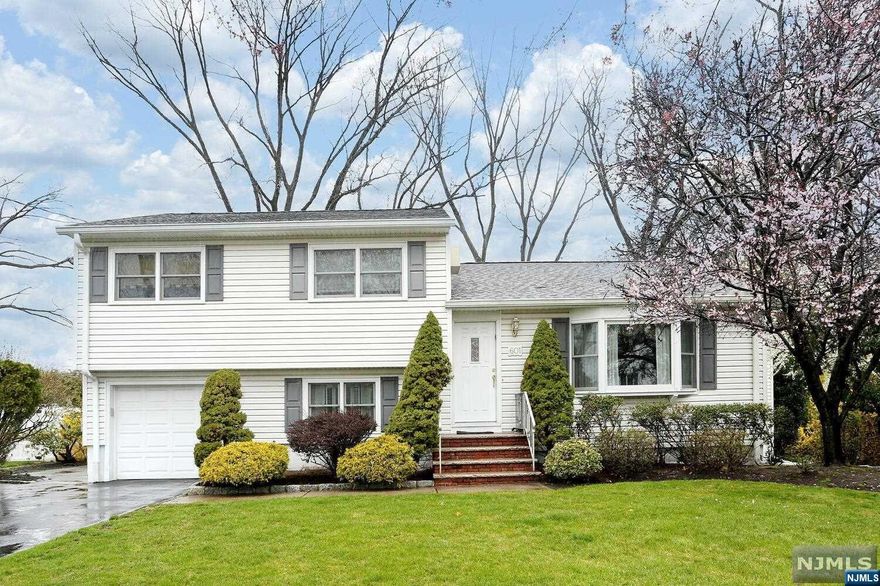 Well maintained expanded split level on cul de sac! Large family room addition with Fireplace! Spectacular location! Entry foyer, sunken living room with built in bookcases, formal dining room with skylight, modern kitchen with vaulted ceiling and skylight, family room addition with gorgeous fireplace! Upstairs three good size bedrooms with plenty of closet space, large bathroom with double sinks and laundry chute. Ground floor den and 2nd bath, convenient garage entry. Basement is nicely finished with rec room, work room and storage. Gas heat, new hot water heater, Generac whole house generator, underground sprinklers, beautiful backyard. Best location in town!