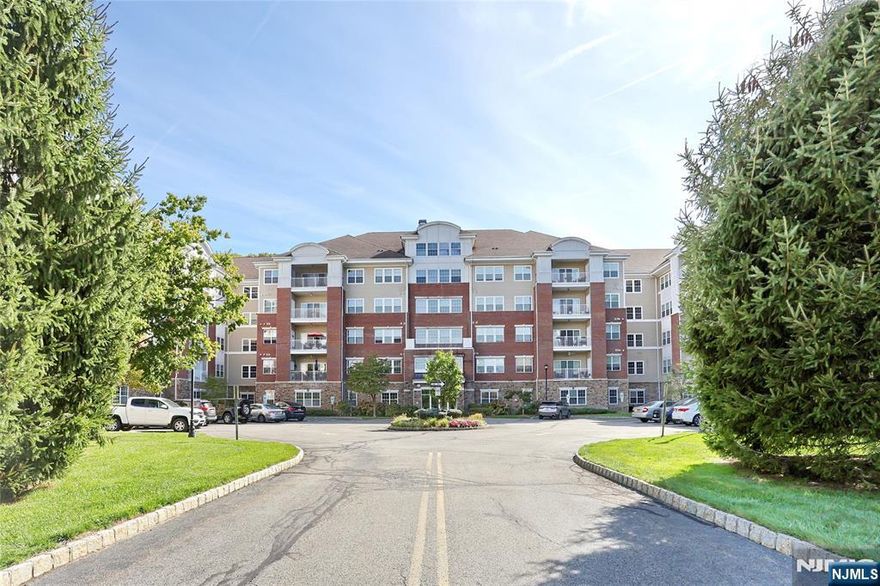 Wonderful 1768 SF 4th floor Colfax unit in Wanaque Reserve, a Del Webb active adult 55+ community. This move-in ready home features hardwood floors...primary & 2nd bedroom floors just replaced, a primary bedroom ensuite with full bath, tray ceiling and WIC, 2nd bedroom, FB, EIK with granite counters, LR DR and den/home office with French doors, adding a touch of elegance. The LR sliding doors open to a private balcony. Amenities include a deeded underground parking spot and 24-hour security. The 20,000 SF clubhouse has a cafe, ballroom, exercise room, theater, sauna, indoor and outdoor pools and more than 45 clubs & activities, which include the travel club (cruises, day & multi-day trips, casino trips, etc.) tennis, pickleball, canasta, poker, golf, etc. Parking spot #44. Wanaque Reserve offers a luxurious lifestyle for its residents with a focus on modern amenities, security and a sense of community. The recent renovation adds a fresh and updated living environment.