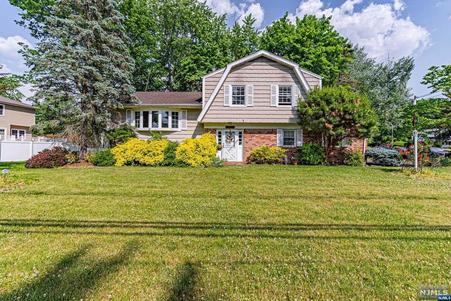 This lovely split level features 3 Bedrooms, 2.5 Bath with a 2 car garage & conveniently located within the Rolling Hills section of Wayne. This home boasts an open concept first floor with a spacious and bright living room, formal dining room, galley kitchen with breakfast bar & lovely sunroom overlooking the back yard! Second floor offers a Primary Bedroom with Bath, 2 additional Bedrooms and a Main Bath. Lower Level provides a spacious family room(can be subdivided into a 4th Bedroom) with laundry and a powder room leading to the backyard and partially finished basement. Great space! Great Potential to make it your own! Enjoy all that Wayne offers: excellent schools (Wayne Valley High School, AWMS, Lafayette), Trader Joe's, Whole Foods, Boys & Girls, Y, PAL, James Roe Pool, Captain Michael Kilroy Memorial Park & more! Near NYC transportation.