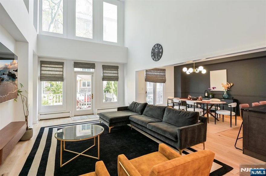 Discover refined living in this beautifully crafted 2,200 sq. ft. duplex condo in the sought-after Shearwater Court community of Port Liberte. This residence embodies upscale comfort with open interiors, abundant light, and timeless sophistication. The striking great room features soaring 18-ft cathedral ceilings that create openness and grandeur. Sunlight flows into the dining area and LR, while sliding doors lead to a private patio oasis, ideal for alfresco dining or mornings outdoors. The chef-inspired kitchen blends function and style with sleek finishes, ample cabinetry, and generous counter space to inspire culinary creativity. A convenient half bath is on the 1st level, perfect for entertaining. Upstairs, the primary suite offers a peaceful retreat with a spa-like en-suite bath and a versatile mezzanine, ideal as a reading nook or home office. Two addl BRs and a full bath complete the 2nd flr, providing privacy and comfort. This home includes central A/C, in-unit laundry, and access to Port Liberte resort-style amenities: 24-hr gated security, lap & infinity pools w/ skyline views, fitness ctr w/ saunas, tennis & basketball courts, dog runs, play areas, and waterfront promenades to Liberty State Park. Onsite conveniences include a dental office & Growing Seeds preschool. Easy NYC commute w/ shuttle to Grove St PATH or ferry directly to Downtown NYC Pier 11. Minutes to highways, Holland Tunnel & Newark Liberty Intl Airport. Pets case by case.