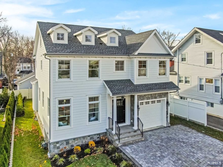 This exquisite new construction home is going to steal your heart. Masterfully crafted, mindfully designed and built w/ careful attention to detail! The stunning exterior transitions seamlessly into the gorgeous interior replete w/ custom mill work & designer finishes. Enjoy an open & easy flowing floor plan w/ an abundance of natural light. Create chef inspired meals in your dream kitchen, warm up by the fireplace in the family rm, and entertain in the elegant dining rm w/ coffered ceilings. Upstairs boasts a generous master suite w/ a spa quality bathroom & walk-in closet, a junior ensuite, 2 more bedrooms, hall bath, and side by side laundry. The 3rd level is finished w/ a bonus rm that easily converts into more bedrooms and the basement is finished w/ 8 ft ceilings, a large open recreation room, 5th bedroom and a full bathroom. Beautiful pavered driveway, attached garage w/ direct entry, and 3 zone HVAC. Prime location near NYC transit & Houses of Worship.