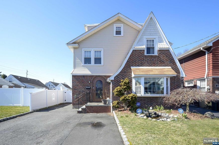 Welcome to this beautifully renovated Tudor style home, featuring four bedrooms and three and a half bathrooms. As you enter through the front door, you are greeted by a spacious and inviting foyer, complete with hardwood flooring and plenty of natural light. The foyer flows seamlessly into a large living room with cozy fireplace & a sliding glass door leading you to the 2 story trex deck and fully fenced private backyard. Adjacent to the living room is a formal dining room, gourmet kitchen, cozy den & half bathroom. Upstairs, you'll find 3 spacious bedrooms, each with its own unique charm and character. The master suite features a luxurious en-suite bathroom, as well as a private deck. The other bedrooms share an additional full bathroom. Other notable features of this home include a 3rd floor bedroom, finished basement w/ plenty of space for home gym, a rec room, laundry and another full bathroom. Home is perfectly located, near transportation, shopping, restaurants and more!