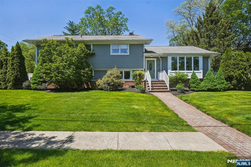 Welcome to Westfield! This gorgeous split-level home has everything to offer. Sunny and bright open floor plan with living room, with custom built in shelves. alcohol fireplace, dining room, gourmet kitchen with state-of-the-art appliances, 2 sinks, 68" fridge/freezer, custom cabinetry, granite countertops, breakfast bar, and separate dining area with sliders that leads out to a deck that overlooks a backyard oasis. Gorgeous, fenced in yard on a 1/3-acre property with lush and flowering landscaping, inground sprinklers, firepit and multiple seating areas. Perfect for entertaining. The first floor has 4 bedrooms, with renovated primary bath with marble double vanity. The lower level offers a large recreation room with flat screen TV and additional bedroom, full bath and laundry room with sliders for outdoor access. Beautifully paved oversized driveway that fits multiple cars with attached garage. All rooms are freshly painted and hard wood floors throughout. Don't miss out on this opportunity to be conveniently located to Westfield's vibrant downtown with shopping, restaurants, parks top rated schools, and transportation to NYC trains and buses.