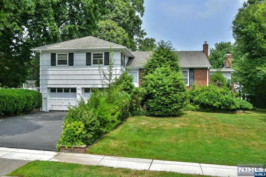 Discover this charming Split-Level home in Oradell's sought-after Latch String neighborhood, offering stunning curb appeal and effortless access to a serene, private backyard perfect for enjoying every season. Bathed in natural light from expansive windows, the floor plan on the main level creates a seamless flow between the living room, dining room, and family room with a cozy fireplace, making it ideal for both relaxation and entertaining. The upper level features three bedrooms just a short flight of stairs up from the main floor, while the ground level includes a fourth bedroom, a convenient half bath, and a work-from-home area. The finished basement provides an additional entertainment haven with a wet bar in the rec room. Freshly painted throughout, this home also boasts a large attached two-car garage. Benefit from top-rated schools & town services. Close to all forms of transportation. This home combines comfort, convenience, & style in a prime location.