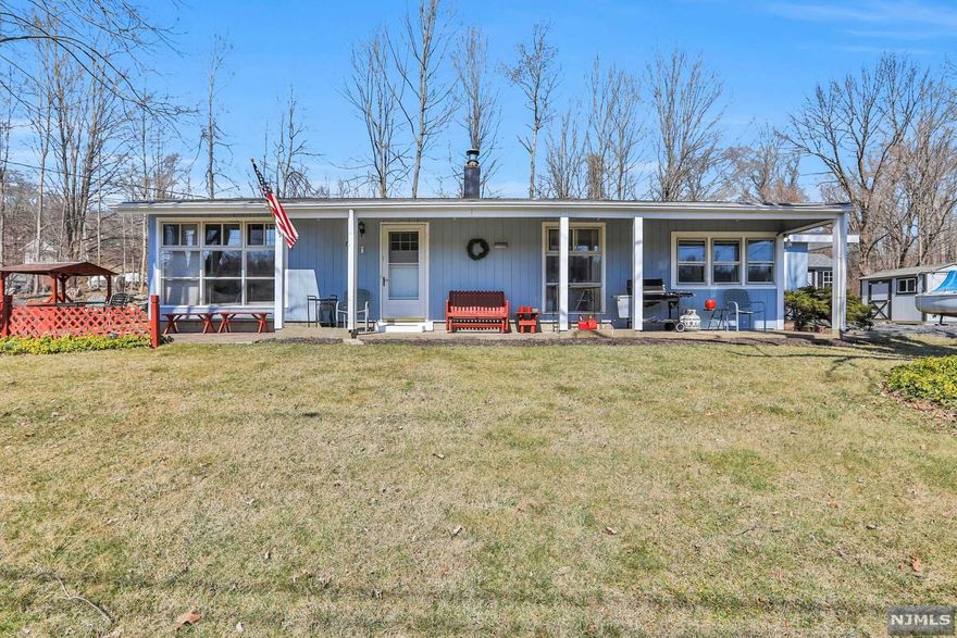 This cozy, sun-splashed home is nestled within walking distance from beautiful Lake Hopatcong. Featuring three bedrooms, a bright kitchen with separate dining room, and a pleasant living room with huge picture window overlooking the lake, this home is perfectly situated for enjoying lake life at its best. The patio with lake views is perfect for entertaining and enjoying warm weather, and the pellet stove in the den will keep you cozy and warm during the winter. Don't miss the opportunity to live within walking distance of Lake Hopatcong and everything its community has to offer.