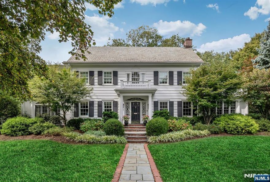 This Iconic Willard Colonial is in a class of its own, offering exceptional curb appeal and a commanding presence on nearly an acre of lush, private grounds with 5,200+sqft of living space. A grand center hall foyer sets the tone, welcoming you into a warm yet breathtaking interior. A front-to-back living room showcases a magnificent fireplace, French doors to the lounge on either side, rich hardwood floors, and exquisite custom moldings and coffered ceiling. The formal dining room evokes memories of family gatherings and elegant entertaining. The lounge, wrapped in beautiful windows, opens through French doors to wraparound blue stone patios overlooking the stunning grounds, complete w/ an outdoor kitchen, gunite pool & waterfall. At the heart of the home is a renovated kitchen, thoughtfully designed with a spacious breakfast area and a family room just off the side, creating an effortless flow for modern living. Highlights include a large walk-in pantry and a striking floor-to-ceiling wine refrigerator, blending function and luxury. The home offers six bedrooms and five-and-a-half baths, including a remarkable primary suite with his-and-her baths, walk-in closets, and a private sunroom/office with balcony. Recently renovated bathrooms throughout further enhance the homeâ€™s timeless appeal. Meticulously maintained and curated with care, this extraordinary estate is a rare offering in one of Ridgewoodâ€™s most coveted neighborhoods. A home to be treasured for generations!