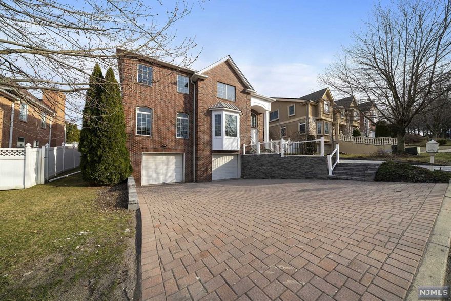Looking for that big, bright, & updated home on a quiet street within 5 minutes of the GWB? Here it is - Magnificent open concept colonial with VERY LOW TAXES in desirable Englewood Cliffs. Be welcomed home into an expansive 2 story entry foyer with long sightlines. Open flow formal living and dining rooms, magnificent living room with custom wood burning fireplace. Brand new gourmet kitchen with S/S appliances, plenty of counter space, ample storage, white custom cabinetry, & butler's pantry. Enormous 2nd level primary suite with double walk in closets, dedicated office, & warm bathroom. 3 large additional bedrooms upstairs. Comfortable in-law/nanny suite. High ceilings in the finished basement featuring full bath, plenty of storage, utilities, rec room, & 6th bedroom. Brand new paver driveway leads to a colossal 3-4 car garage! Private fenced in backyard with new paver patio. Newly installed & refinished flooring throughout. New roof, new HVAC. A true gem in a premium location!