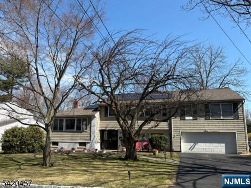 Located on a private cul-de-sac street in the heart of Pleasantdale, this spacious 6-bedroom/5-bath home is perfect for both living and entertaining. Beautifully finished on 4 levels, the interior features hardwood floors, recessed lights, a renovated top-of-the-line kitchen, and a huge deck with incredible views. The custom kitchen features granite countertops, stainless steel appliances, a double oven, and a center island with a skylight, which adds abundant natural light. The formal dining room opens onto the living room, which can accommodate crowds of any size for holidays and special occasions. fenced-in yard with a storage shed. The second floor has 5 large bedrooms, adorned with generous closets. The primary en-suite features wall-to-wall custom built-in closets and a private full bathroom. The lower level features a screening room, gym, and additional closets and storage space. Other highlights include: new roof, doors, driveway and walkway, LED lighting, and NEST thermostats. This home is close to recreation and houses of worship, and is great for an NYC commuter.