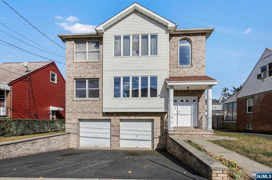 22 year young 2 family w/2 car garage & driveway for 2 cars only 1 block to NYC Bus. This conveniently located home has Living room, dining room, kitchen, 3 bedrooms and 2 baths on each floor. Primary bedrooms have private full bath & walk in closet. Deck off 1st floor kitchen. Ground level is finished with recreation room, full bath and access to 2 car garage. Hardwood floors in living area, wall to wall carpet in bedrooms, 2 separate gas heating systems & central air units (1st floor has 2 zones), 2 hot water heaters, separate electric and gas meters. 1st floor available for immediate occupancy. 2nd floor has tenant $2,500 per month lease expires 8-30-25. Lovely rear yard.