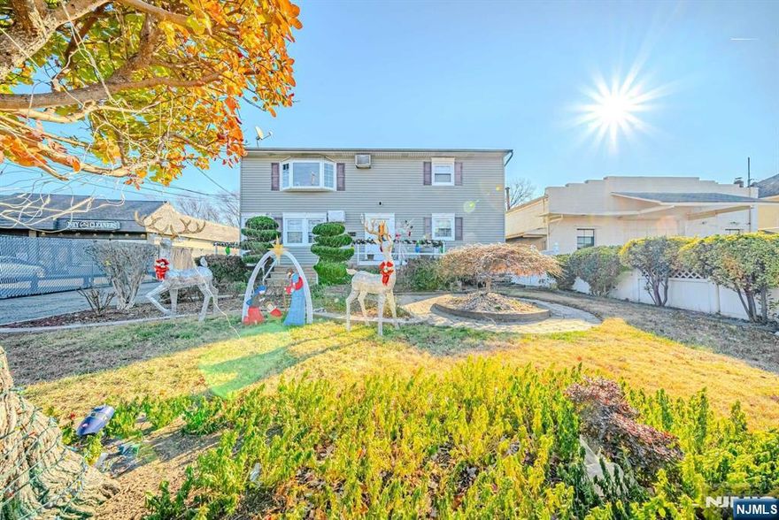 Welcome to this spacious two-family home, offering a fantastic layout with 6 bedrooms and 3 full bathrooms. Both floors feature the same layout, with a bright and airy living room and dining room combo. The eat-in kitchen is ideal for everyday meals, and the finished walkout basement provides additional living space, including a summer kitchen, full bathroom, bonus room, and a cozy family room. Step outside to the expansive backyard, offering plenty of space for outdoor activities. With a detached 2-car garage and parking for 8-10 cars, convenience is key. This home is ideally located close to NYC transportation, schools, and restaurants. Don't miss out on this incredible opportunity!