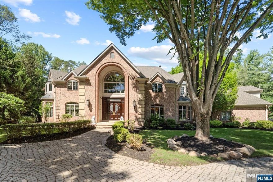 Set on a peaceful cul-de-sac with direct views of Lake Tappan, this distinguished French-inspired residence offers approx. 8,000 sq ft of refined living space. A leading entry introduces the home with timeless elegance, complemented by three staircases and an elevator that services all three floors for effortless access. The grand marble foyer opens to an expansive great room with a dual-sided fireplace, while the custom kitchen - enhanced with premium finishes - flows into a dramatic two-story solarium overlooking a grotted pool with waterfall, ideal for private relaxation or entertaining. A private main-level suite features dual sitting areas, dual walk-in closets, and a spa-style bath. The second level includes multiple bedrooms with shared baths, a dedicated media or game room, guest accommodations, and a full laundry room. Professionally landscaped with mature plantings, this exceptional home blends timeless design and modern comfort in one of Old Tappanâ€™s most sought-after settings.