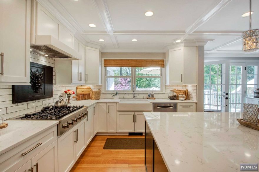 Spectacular updated Colonial - the perfect blend of modern style and classic detail. Featuring new gourmet kitchen with quartz countertops, huge sit-up island, coffered ceiling, stunning floor and new Bosch appliances. The Entry Vestibule opens to the Front Porch, where you can enjoy it's elegance and charm throughout the seasons. Step into the Foyer with checkerboard marble floor, and picturesque stairwell open to Formal Living Room with book cases and panelling detail. The Formal Dining Room /French Doors lead to a fabulous Outside Covered 4 Season Porch with fans and infrared heaters and Mahogany Deck with room to Entertain and BBQ! The Family Room, features stone fireplace/raised hearth, panelling and coffered ceiling. A 2nd Floor Master Bedroom Suite includes new Master Bathroom and large Walk-in Closet. Finished Basement with Rec Room, Gym, Bath and huge Laundry. Beautiful Mature Yard with Koi Pond, Waterfall, 'Garden Room' Stone Patio, Sprinklers, Landscape Lighting. A GEM!