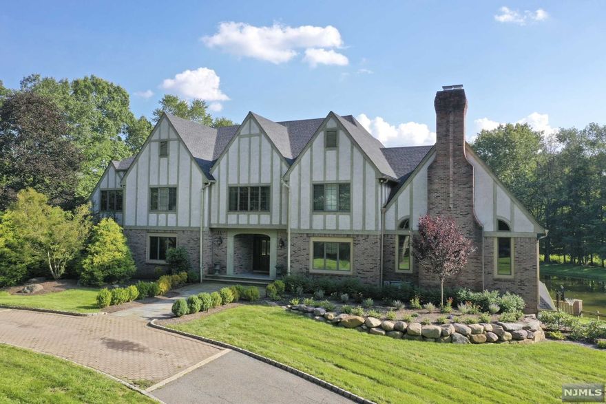 Country Living only 25 miles to NYC! This 5BR estate with approx. 6,200 sf (per tax records) is situated on a breathtaking 2.1 acre property with private/shared pond, swimming pool and rolling hills adjacent to the Saddle River. Indoors is just as amazing with Great Room featuring vaulted ceiling and Fireplace while the paneled Library overlooks the scenic property. The Gourmet Kitchen and Breakfast Rm have another fabulous view of the property! Rounding out the main floor is FLR, FDR, Library, Office, Guest Suite w/FBA + Laundry. The 2nd floor has a Primary Suite with 2 WIC, Sitting Room and Lux. MBA plus there are 3 add'l BR's, 2FBA and another Office/BR. The Lower Level is an Entertainer's Delight with Indoor/Outdoor entertaining space including Bar, 2 Lounge Areas, Billiards Room, Wine Cellar, Gym, FBA w/Sauna & Steam Room/Shower! Gunite Pool. 3-car Garage. Train to NYC only 4 miles away! All this plus LOW SADDLE RIVER TAXES (less than $27,000/yr)!