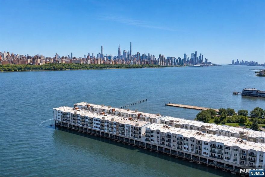 The epitome of waterfront living awaits in this stunning residence showcasing unobstructed views of the Hudson River and New York City. This exceptionally spacious 1495 SQFT two-bedroom, two-bathroom home features an open floor plan, expansive foyer, designer kitchen, beautiful hardwood floors throughout, office/den with custom French doors, and a private balcony. Thoughtful upgrades include a new hot water tank, windows, appliances, and an expanded laundry area. The Promenade is a private 24-hour guard gated community in the heart of Edgewater, offering an exceptional lifestyle, with on-site amenities including a landscaped courtyard, resident lounge, fitness center with locker rooms, showers, sauna, and whirlpool. One-car garage parking is included, while restaurants, shopping, and convenient access to NYC transportation are just moments away.