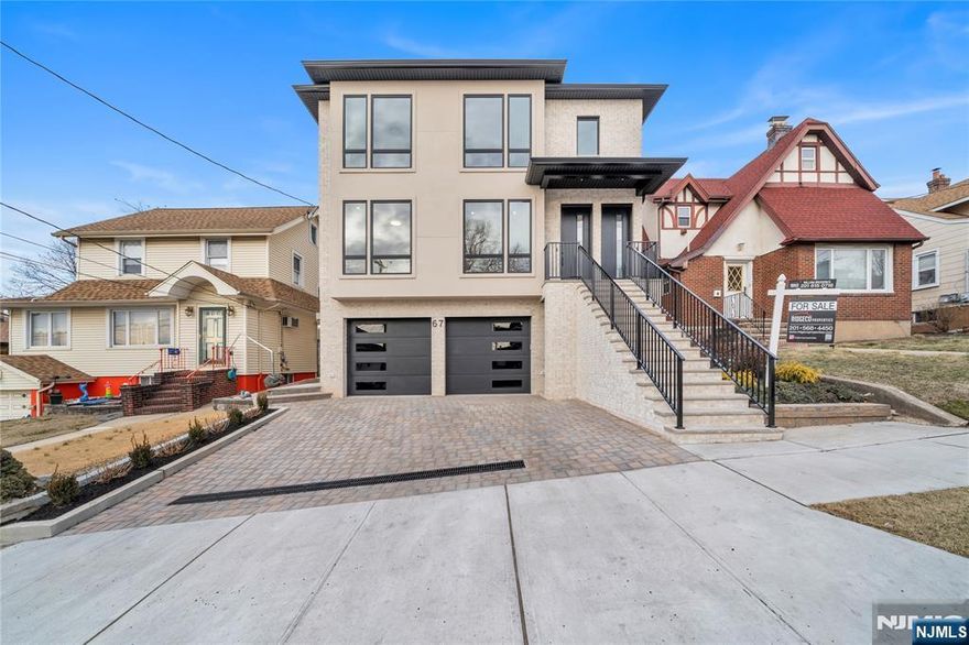 Introducing 67 W Harwood Terrace, a newly constructed two-family home located on a quiet residential street in Palisades Park. Each unit offers 3 bedrooms and 2 full bathrooms, featuring spacious living rooms with built-in electric fireplaces, dining areas, and modern kitchens with custom cabinetry, quartz countertops, under mount lighting, and a GE Cafe appliance package. The primary bedrooms include en suite bathrooms and walk-in closets, plus two additional bedrooms and a hallway bathroom. The basement includes a 2-car garage, ample storage space, and a bonus apartment with a separate entrance, living room, summer kitchen, 2 bedrooms, and a half bath.