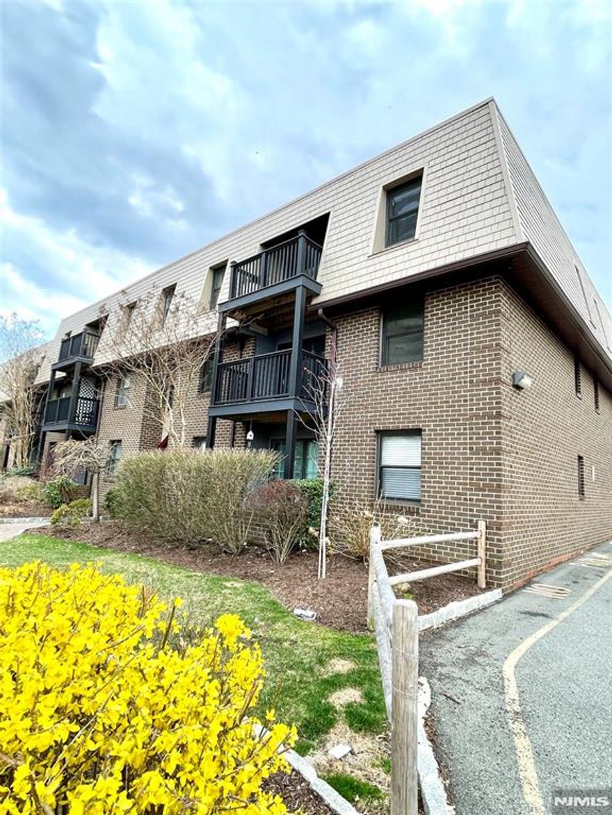 This bright and airy one-bedroom apartment, featuring one full bath with a window, is located on the top floor corner unit. The unit includes a washer and dryer, central air conditioning and heating, a lovely wood-burning fireplace, and a sliding glass door that opens to a balcony. There are two designated parking spaces. NJ transit bus to NYC across street. This exceptional apartment is ready for a new owner to add their personal taste.