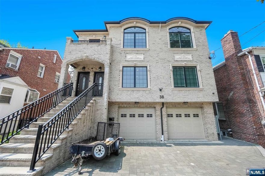 Modern oversized top/bottom-style two-family home, second floor. Spacious open layout featuring a top-of-the-line kitchen with custom cabinets, a large island, and a wet bar perfect for entertaining. Radiant heated floors throughout the home provide ultimate comfort. Enjoy the balcony conveniently located off the living room. Additional Features: Solar energy system with a fixed electric bill of $200/month. EV charger installed in the garage.