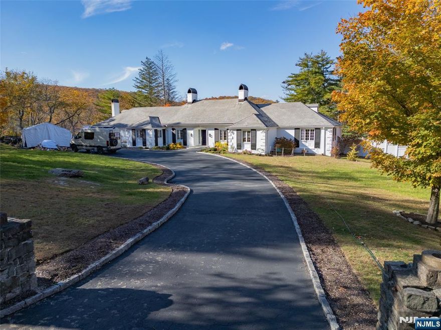 Welcome to 18 Pepperidge Tree Terrace in Smoke Rise, Kinnelon.Elegant Country French Ranch on a cul-de-sac with a 5.48 Acre lot. This sun-filled home offers 4 spacious bedrooms and 2.5 renovated bathrooms, including a stunning primary suite with trayed ceiling, honed marble dual-sink vanity, Toto bidet, and heated towel rack.The newly designed eat-in kitchen features modern cabinetry, marble island, granite counters, premium appliances, and two dishwashers. Open floor plan flows into the family room ideal for entertaining.Outdoor highlights include a saltwater pool, smokeless fire pit area, and a charming "Potter's Hut currently used as a home office. Beautifully landscaped yard with mature trees and gardens.Added features: backup generator, Wi-Fi thermostats, HVAC UV lights, dual-zone heating/cooling, wood-burning stove, and pre-wired home theater. Close to top-rated schools and NYC bus access.A rare Smoke Rise opportunity!