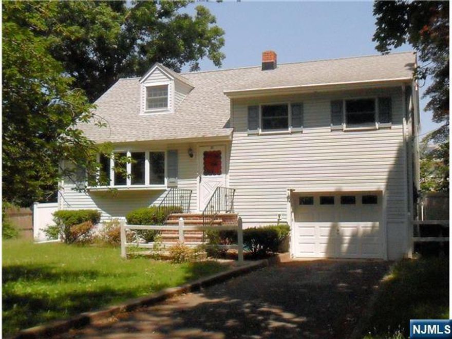 Don't miss out on this spacious split-level home, perfectly situated in a quiet neighborhood. Located near public transportation taking you all the way to NYC, shopping of all needs, parks and entertainment for all ages. Set foot in your new home with hardwood floors through-out, sunny bay windows overlooking the beautiful cherry blossom tree in the front yard and the greenery in the back. A perfect layout for company with the kitchen entering into both the spacious living and dining rooms. Go down a level to your size-able garage leading out to the privacy fenced back yard with a perfectly laid patio to grill with friends. Down one more level to your basement full of opportunities for storage, a gym and more! Head back inside and go up one floor to your roomy Master and 2nd bedroom, still complete with hardwood floors and plenty of closet space. Up one more floor to your 3rd bedroom which has ample room to make into an office, playroom